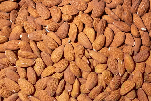 Scattered Almonds. Background from Almond Nuts. Natural High-Calorie Snacks photo