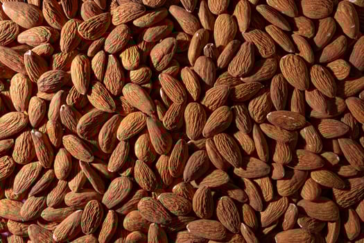 Scattered Almonds. Background from Almond Nuts. Natural High-Calorie Snacks photo