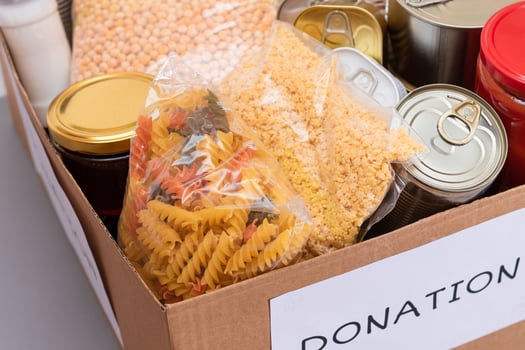 Donation Box of Free Food. Carton Box with Canned Food, Cereals and Grocery. Meal Reserves. Emergency Food Storage in Case of Crisis. Free Social Help, Blessings and Care. Strategic Food Supplies photo