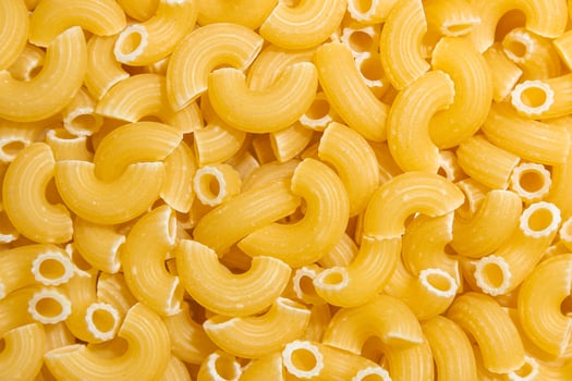Uncooked Chifferi Rigati Pasta. A Culinary Canvas of Chifferi Rigati, Creating a Lively and Textured Background for Gourmet Cooking. Dry Pasta. Raw Macaroni - Top View, Flat Lay photo
