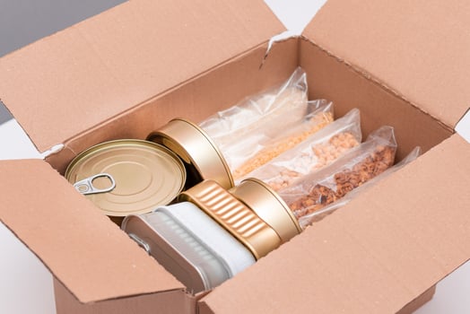Food Reserves or Donation Box. Carton Box with Canned Food, Cereals and Grocery. Emergency Food Storage in Case of Crisis. Free Social Help, Blessings and Care. Strategic Food Supplies photo