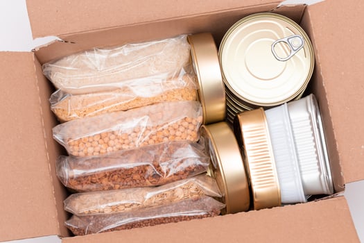 Food Reserves or Donation Box. Carton Box with Canned Food, Cereals and Grocery. Emergency Food Storage in Case of Crisis. Free Social Help, Blessings and Care. Strategic Food Supplies photo