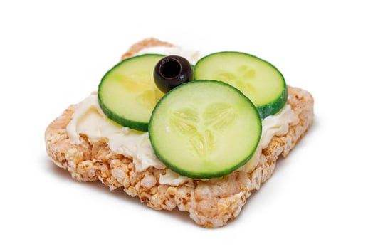 Rice Cake Sandwich with Fresh Cucumber, Cream Cheese and Olives - Isolated on White. Easy Breakfast. Quick and Healthy Sandwiches. Crispbread with Tasty Filling. Healthy Dietary Snack - Isolation photo