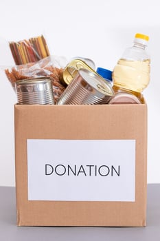Donation Box of Free Food. Carton Box with Canned Food, Cereals and Grocery. Meal Reserves. Emergency Food Storage in Case of Crisis. Free Social Help, Blessings and Care. Strategic Food Supplies photo