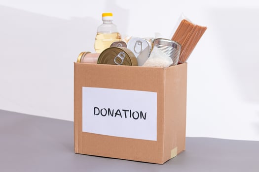 Donation Box of Free Food. Carton Box with Canned Food, Cereals and Grocery. Meal Reserves. Emergency Food Storage in Case of Crisis. Free Social Help, Blessings and Care. Strategic Food Supplies photo