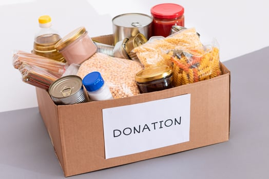 Donation Box of Free Food. Carton Box with Canned Food, Cereals and Grocery. Meal Reserves. Emergency Food Storage in Case of Crisis. Free Social Help, Blessings and Care. Strategic Food Supplies photo