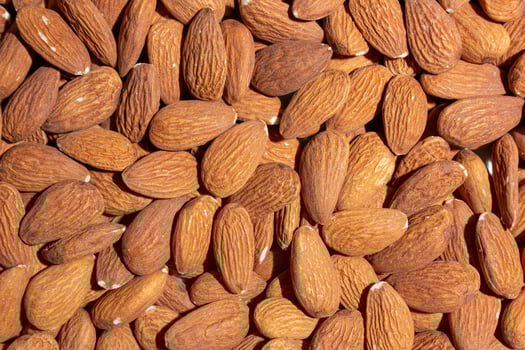 Scattered Almonds. Background from Almond Nuts. Natural High-Calorie Snacks photo