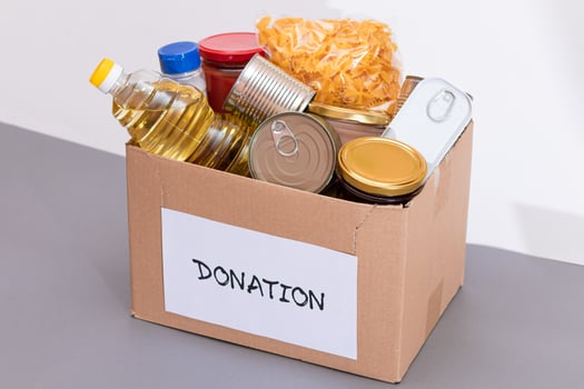 Donation Box of Free Food. Carton Box with Canned Food, Cereals and Grocery. Meal Reserves. Emergency Food Storage in Case of Crisis. Free Social Help, Blessings and Care. Strategic Food Supplies photo