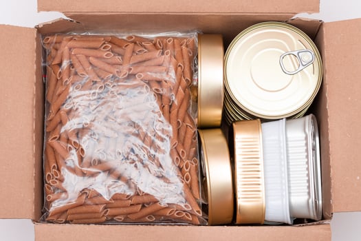 Food Reserves or Donation Box. Carton Box with Canned Food, Cereals and Grocery. Emergency Food Storage in Case of Crisis. Free Social Help, Blessings and Care. Strategic Food Supplies photo