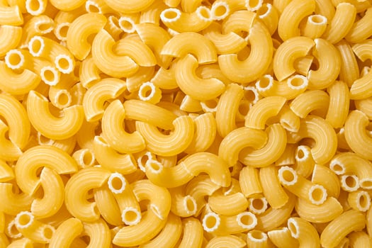 Uncooked Chifferi Rigati Pasta. A Culinary Canvas of Chifferi Rigati, Creating a Lively and Textured Background for Gourmet Cooking. Dry Pasta. Raw Macaroni - Top View, Flat Lay photo