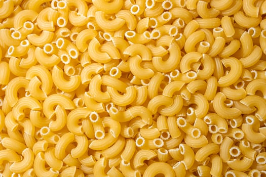 Uncooked Chifferi Rigati Pasta. A Culinary Canvas of Chifferi Rigati, Creating a Lively and Textured Background for Gourmet Cooking. Dry Pasta. Raw Macaroni - Top View, Flat Lay photo