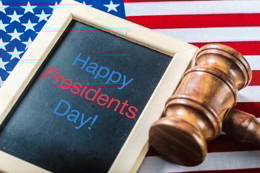 the text happy presidents day written in a chalkboard and a flag of the United States photo