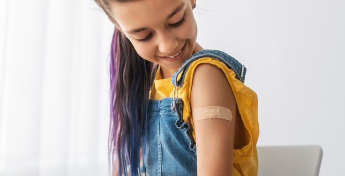 Healthcare And Inoculation Concept. Portrait Of Smiling Teen Patient Showing Vaccinated Arm With Plaster On Shoulder After Coronavirus Vaccination, Looking At Hand. Antiviral Vaccine, Banner, Panorama photo