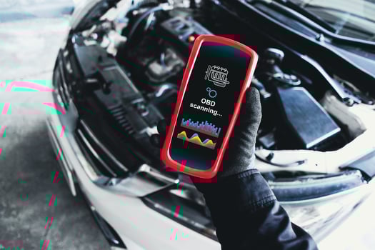 OBD scanner tools , OBD Scanner in use by mechanic over car engine background for analysis engine system problems , Car repair concept photo