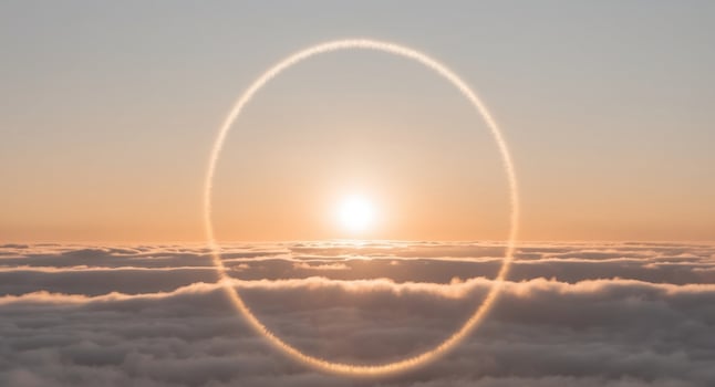 A circle of smoke is seen above the clouds photo