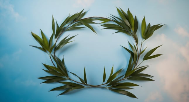 A wreath made of green leaves on a blue sky background photo