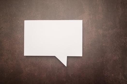 Top view of a blank white speech bubble over vintage background photo