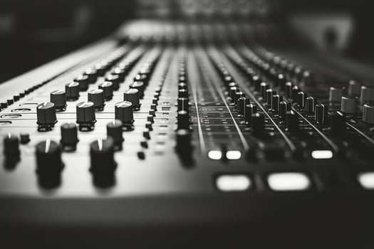 Close up view of audio mixing console with knobs and controls during music production session photo