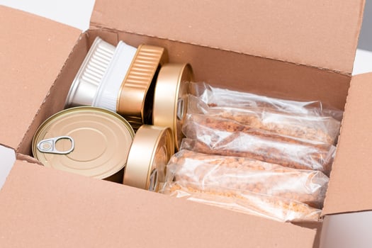 Food Reserves or Donation Box. Carton Box with Canned Food, Cereals and Grocery. Emergency Food Storage in Case of Crisis. Free Social Help, Blessings and Care. Strategic Food Supplies photo