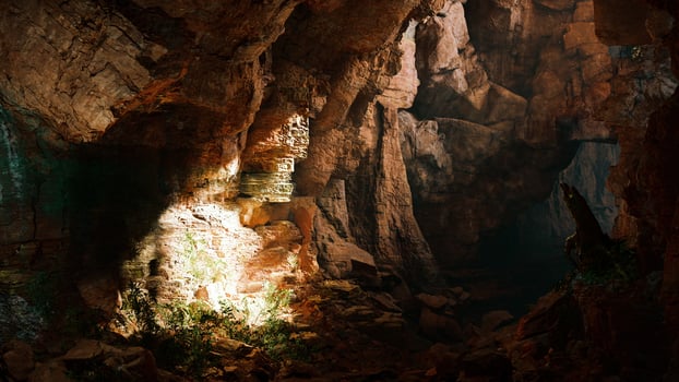 A mysterious cave illuminated by a beam of light photo