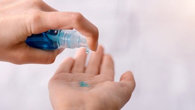 Woman disinfect hands antiseptic during coronavirus quarantine photo