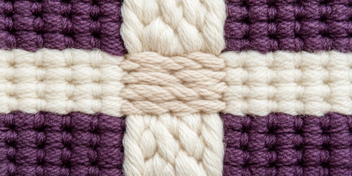 Close-up of cozy fabric texture featuring rich purple and beige tones in warm light for inviting home decor photo