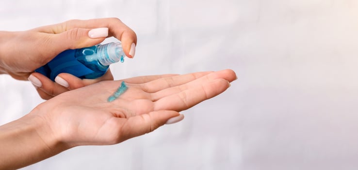 Disinfection during 2019-ncov epidemic. Woman rubs hands with antiseptic photo