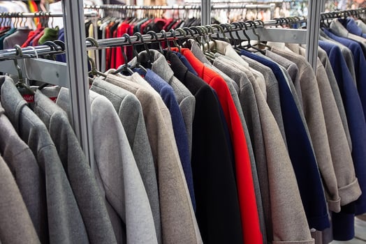 Fashionable women's coat on hangers in a clothing store photo