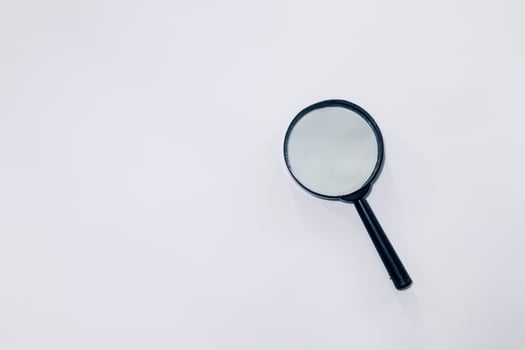 A magnifying glass on a white background photo