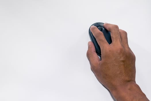 A male hand holding a computer mouse on a white background photo