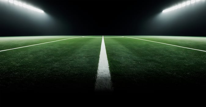 empty green grass stadium with lights on the night sports soccer field photo
