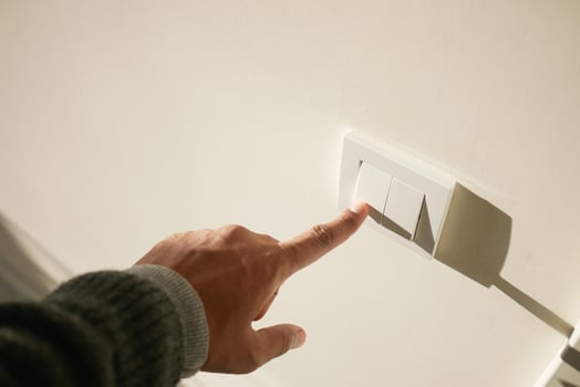 A finger turning on lighting switch . photo
