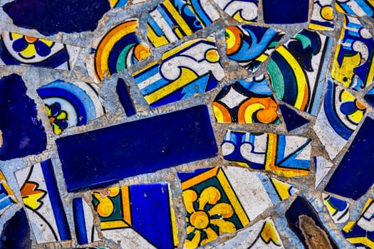 A blue collection of decorative ceramic tiles displays an array of intricate patterns and vibrant colors, including blues, reds, and greens photo