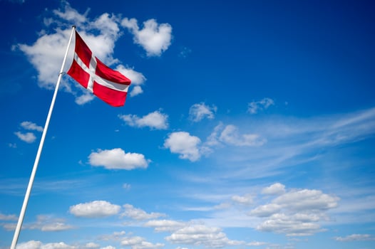 Danish flag and blue sky and clouds photo