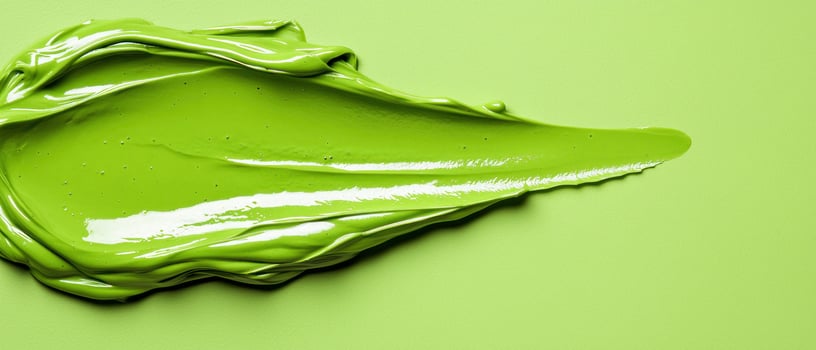 Vibrant green paint on a smooth surface, showcasing rich color and texture. photo