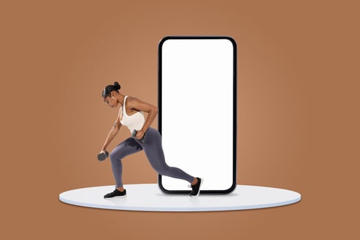 A woman engages in a workout while holding dumbbells, positioned in front of a large smartphone screen. She is focused and demonstrating a lunging exercise. photo