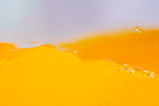 Close up bright orange juice splash texture for health and nature waves, Beautiful waves curve and little bubbles smooth for garphic design and background photo