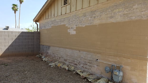 Removing Old Chipped and Flaky Paint from a Tan Brick House photo