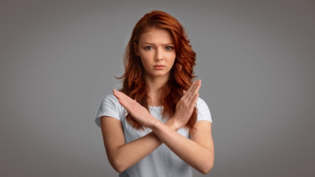 Self-Isolation. Determined Girl Gesturing No Crossing Hands Forbidding Something Posing Over Gray Background. Studio Shot, Panorama photo