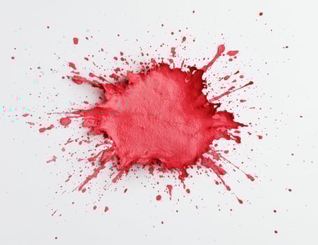 Vibrant red paint splash on white background photo