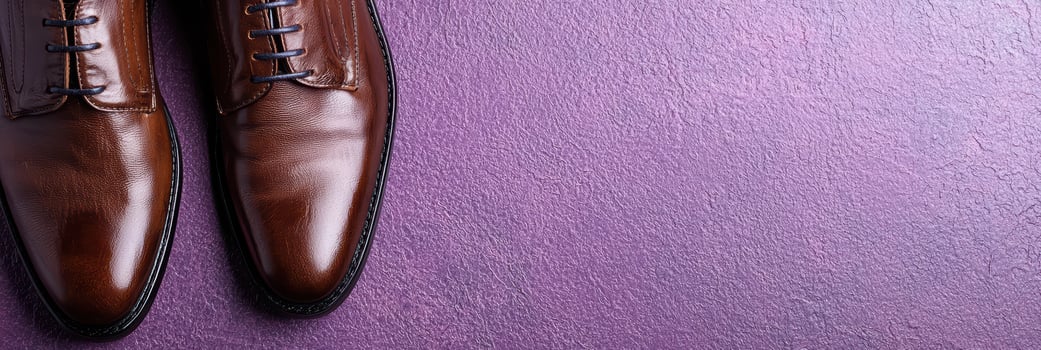 elegant brown leather shoes on purple background photo