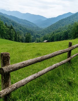 Scenic mountain landscape with wooden fence in foreground photo