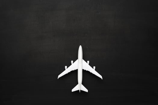 Miniature airplane on black background photo