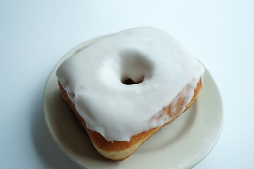 Close up Vanilla glazed donut on white table photo