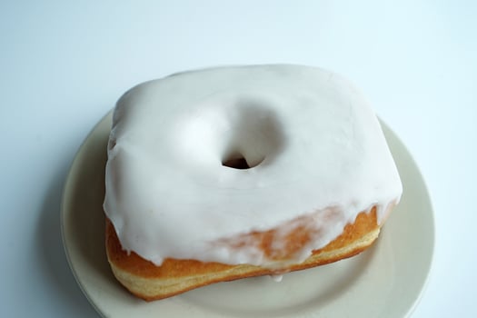 Close up Vanilla glazed donut on white table photo