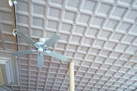 Crave ceiling design and decoration decorated with white cement concrete frame and hanging electrical fan photo