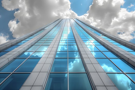 Modern Skyscraper with Reflective Glass Against a Cloudy Sky - Urban Architecture photo