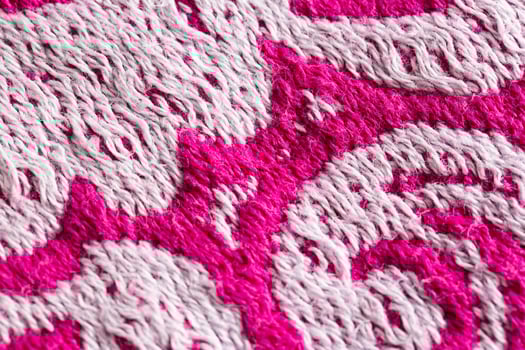 texture of burgundy terry towel with a pattern, close-up. Background, vinous photo