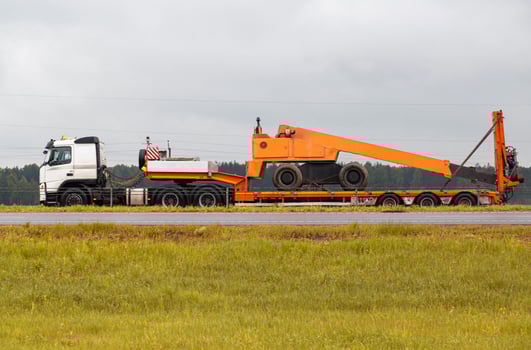 Transportation of oversized cargo by truck. Tower for carrying out repair work on a trailer. photo