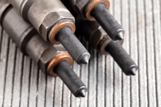 Needles and nozzles on nozzles from a diesel engine. Deterioration of the fuel system of the car, macro photo